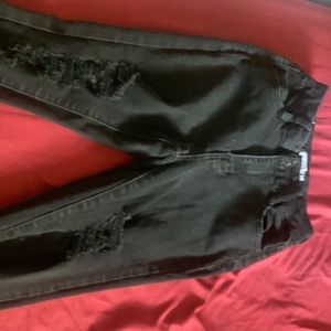 A pair of slightly loved black jeans, size 0 in juniors